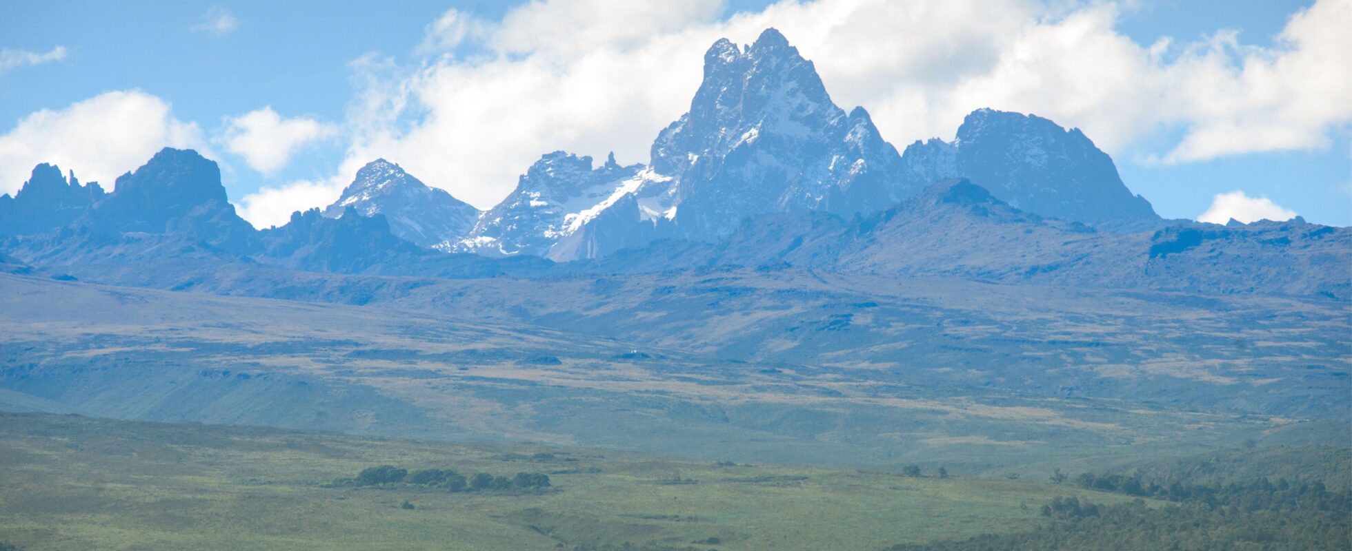 Mount Kenya sett fra avstand med grønt landskap foran